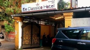 The entrance to De Classico Hotel with a gated entrance and a sign above. - De Classico Residency (Ayodhya)