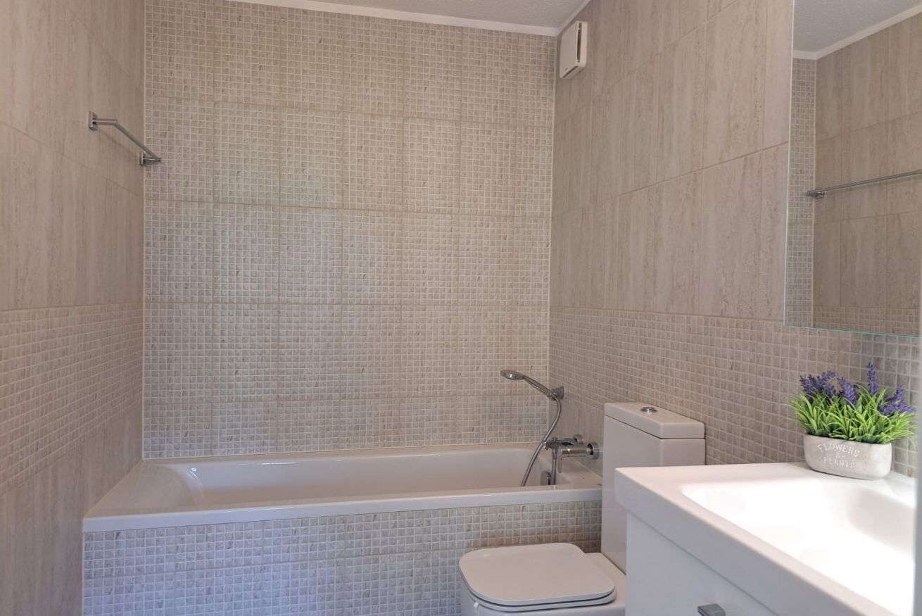 Un baño moderno con bañera, inodoro y lavamanos.