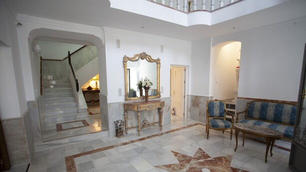 A spacious lobby with a marble floor, a grand staircase, a large mirror, and classic furniture. - RUSTIC & ROMANTIC ROOM (Cuevas de Almanzora)