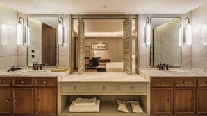 A modern bathroom with a double sink, wooden cabinets, and a mirror. - Moon River Puyue Hotel (Tongzhou)