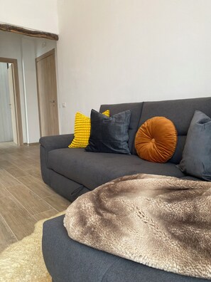 A modern living room with a grey sofa, a brown furry throw, and various cushions. - CasadiCamp (Scauri)