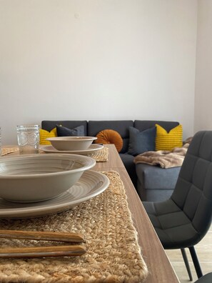 A dining table set with plates and a glass, a woven placemat, and a chair. - CasadiCamp (Scauri)