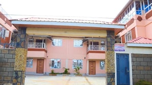 A building with a central entrance, two-story structure, and a sign indicating a Brindelle Suite. - Shirpelle Suites Kiamunyi (Nakuru)
