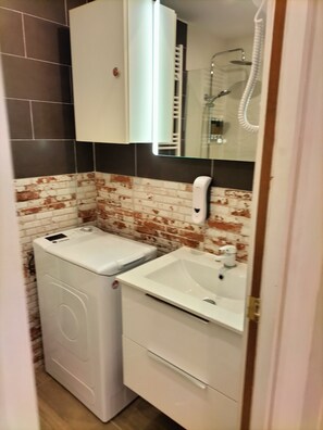 Shower, hair dryer, towels, soap