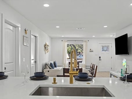 Interior. You’ll love this stylish 4BR/2BA East Austin home—perfect for families, groups & business travelers. Designed for comfort, it features an open kitchen with new appliances, a large dining area, TVs in every room, and plush bedding.