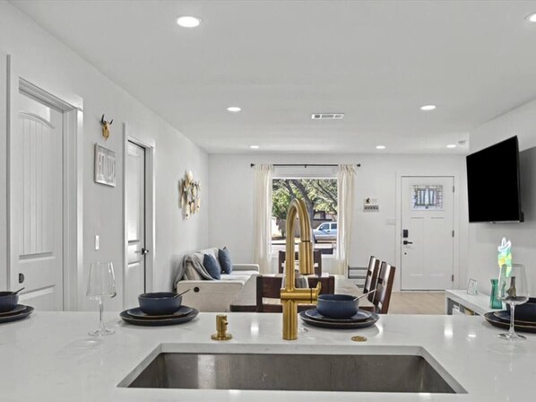 Interior - You’ll love this stylish 4BR/2BA East Austin home—perfect for families, groups & business travelers. Designed for comfort, it features an open kitchen with new appliances, a large dining area, TVs in every room, and plush bedding. (Austin)