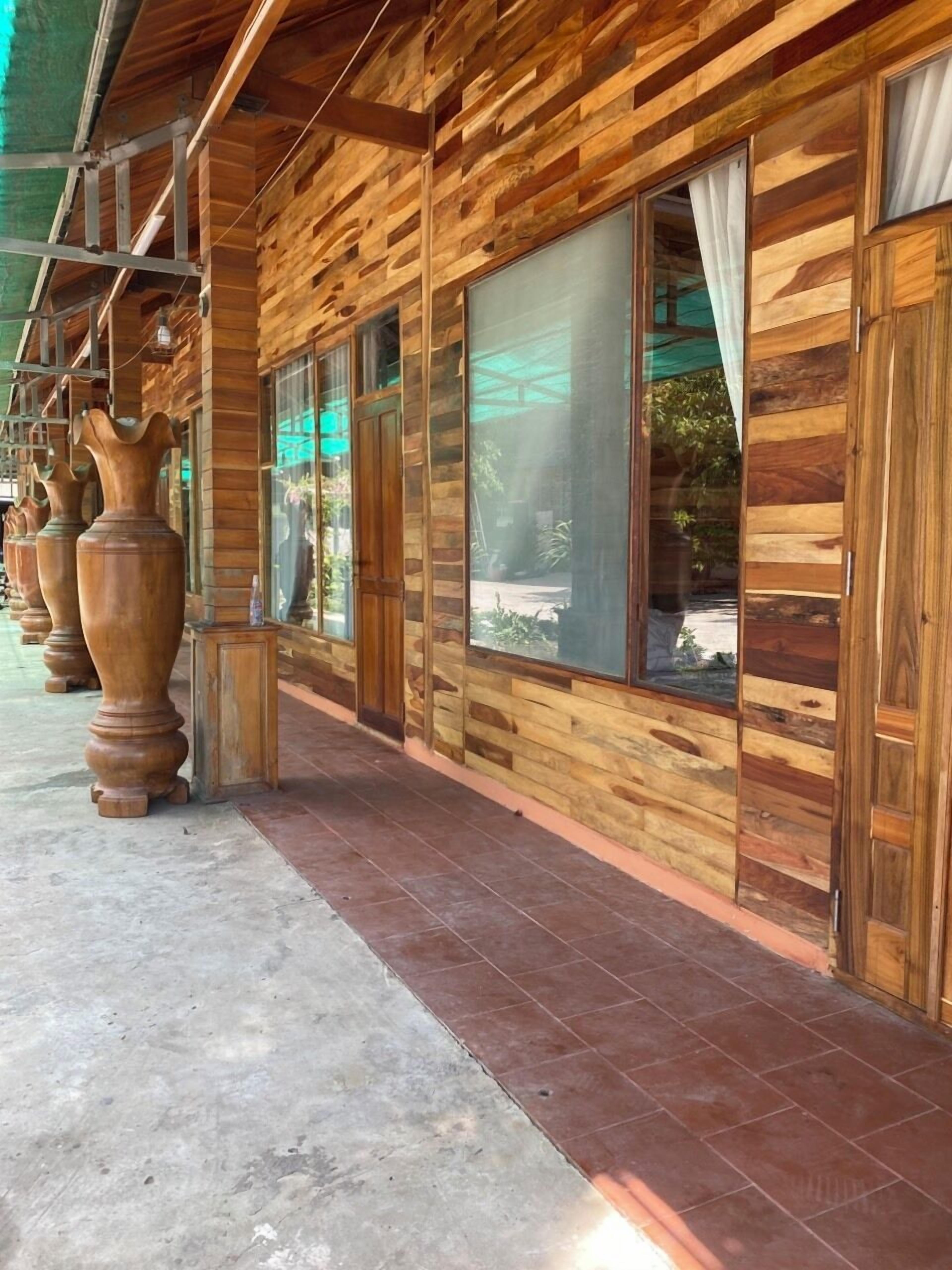 Un edificio de madera con amplias ventanas y un corredor cubierto.