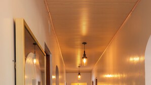 A hallway with a wooden ceiling, tiled floor, and multiple doors. - Gatundu Peaceful Tea Farm Stay w/activities (Gatundu)