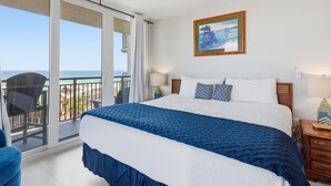 A bedroom with a large bed, a balcony with a view of the ocean, and a painting on the wall. - Nautilus 2511 Gulf View 2 BR/2 BA 5th Floor 2026 REMODEL! (FORT WALTON BEACH)