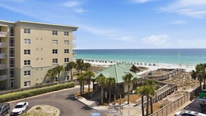 A beachfront hotel with a parking area, a beach, and a boardwalk. - Nautilus 2511 Gulf View 2 BR/2 BA 5th Floor 2026 REMODEL! (FORT WALTON BEACH)
