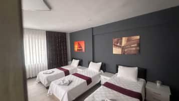 Economy Triple Room | Minibar, desk, laptop workspace, free WiFi