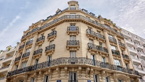 A multi-story building with ornate balconies and classical architectural details. - Elegant and modern apartment  Eiffel Tower (Paris)