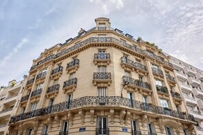 A multi-story building with ornate balconies and classical architectural details. - Elegant and modern apartment  Eiffel Tower (Paris)