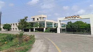 A modern building with a sign reading "MANGO RETREAT". - Mango Retreat Hotel and Resort (Bhopal)