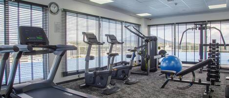 A gym with treadmills, elliptical machines, and a rowing machine.