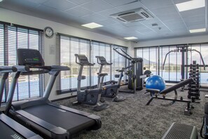 A gym with treadmills, elliptical machines, and a rowing machine. - Amaryllis Hotel (Blantyre)