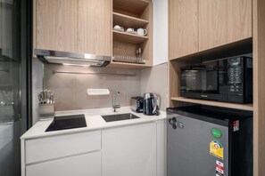 A compact kitchen with a built-in microwave, a toaster, and a coffee maker. - Skypark Aurora, One Bedroom 2312 1B Deluxe (Choeng Thale)