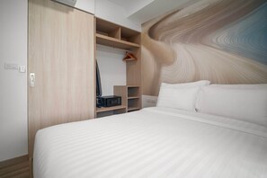 Une chambre moderne avec un grand lit, une armoire en bois et des étagères intégrées.