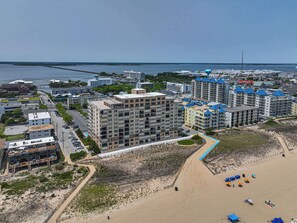 A coastal residential area with high-rise buildings, a beach, and a clear view of the ocean. - Ocean Front Condo with Pool (Ocean City)