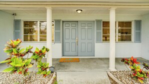 A house with a front porch, a blue door, and a doormat. - 2 Mi to Beach: Home w/ Pool in Venice (Venice)