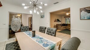 A dining area with a table set for six, a chandelier, and a view into another room. - 2 Mi to Beach: Home w/ Pool in Venice (Venice)