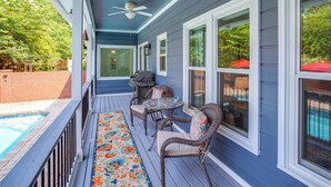 A covered porch with a pool, outdoor seating, and a ceiling fan. - 4 Mi to Lake Murray: Pet-friendly Home w/ Pool! (Irmo)
