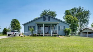 A single-story house with a front porch, a driveway, and a truck parked in front. - Mill Springs Place Marina Access & Boat Parking! (Monticello)