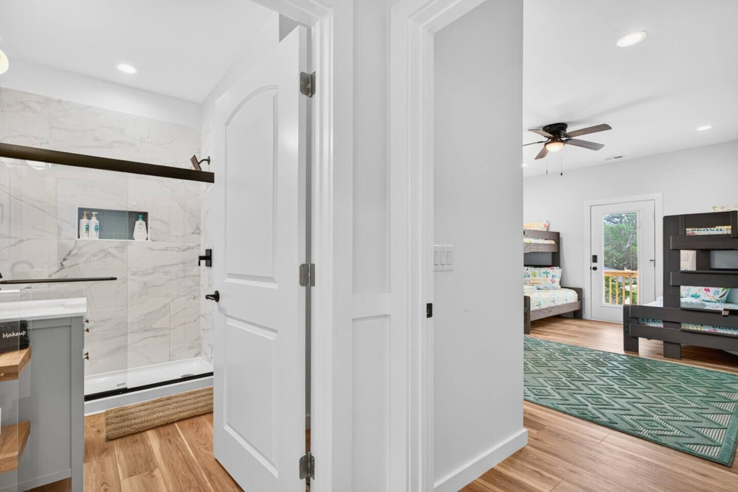 A modern kitchen with marble backsplash, a wooden countertop, and a built-in oven.