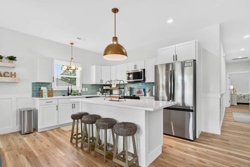 Lux Oak Island Retreat | Walk to Beach | Golf Cart + Private Suite + Fenced Yard!