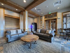 A spacious lobby with two sofas, a coffee table, and a refrigerator. - Top-Floor River Run Gem, Walk to Gondola, Hot Tub (Keystone)
