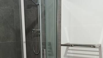 Shower, hair dryer, towels, shampoo