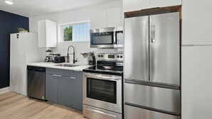 A modern kitchen with stainless steel appliances, a dishwasher, and a window providing natural light. - Best of Knox Henderson - 1BD/1BA Style & Comfort (Dallas)