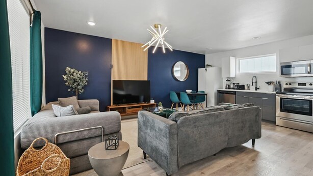 A modern living room with a sofa, TV, and dining area. - Best of Knox Henderson - 1BD/1BA Style & Comfort (Dallas)