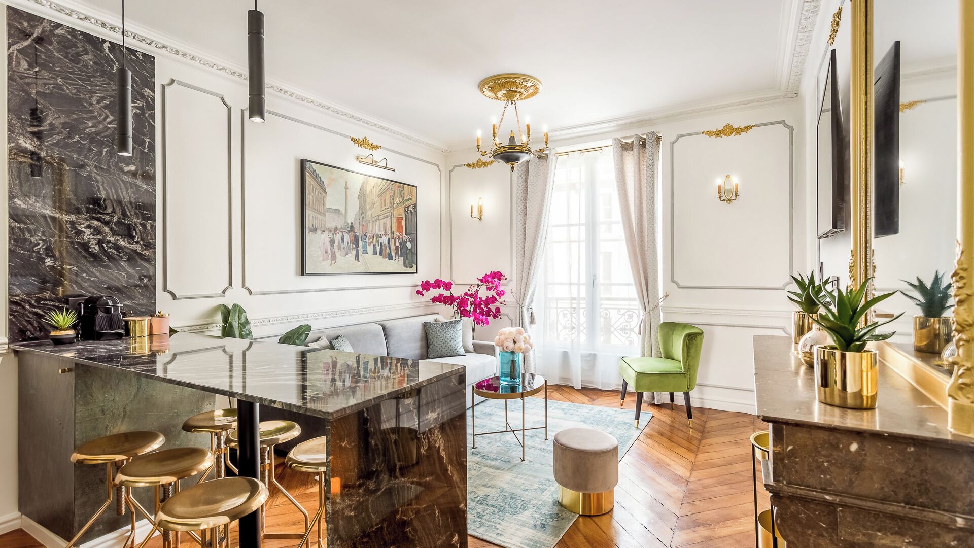 A modern living room with a marble bar, a green armchair, and a large painting on the wall.