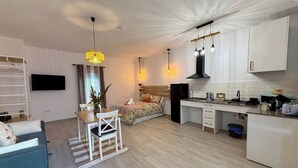 A modern apartment with a living area, dining space, and kitchen.