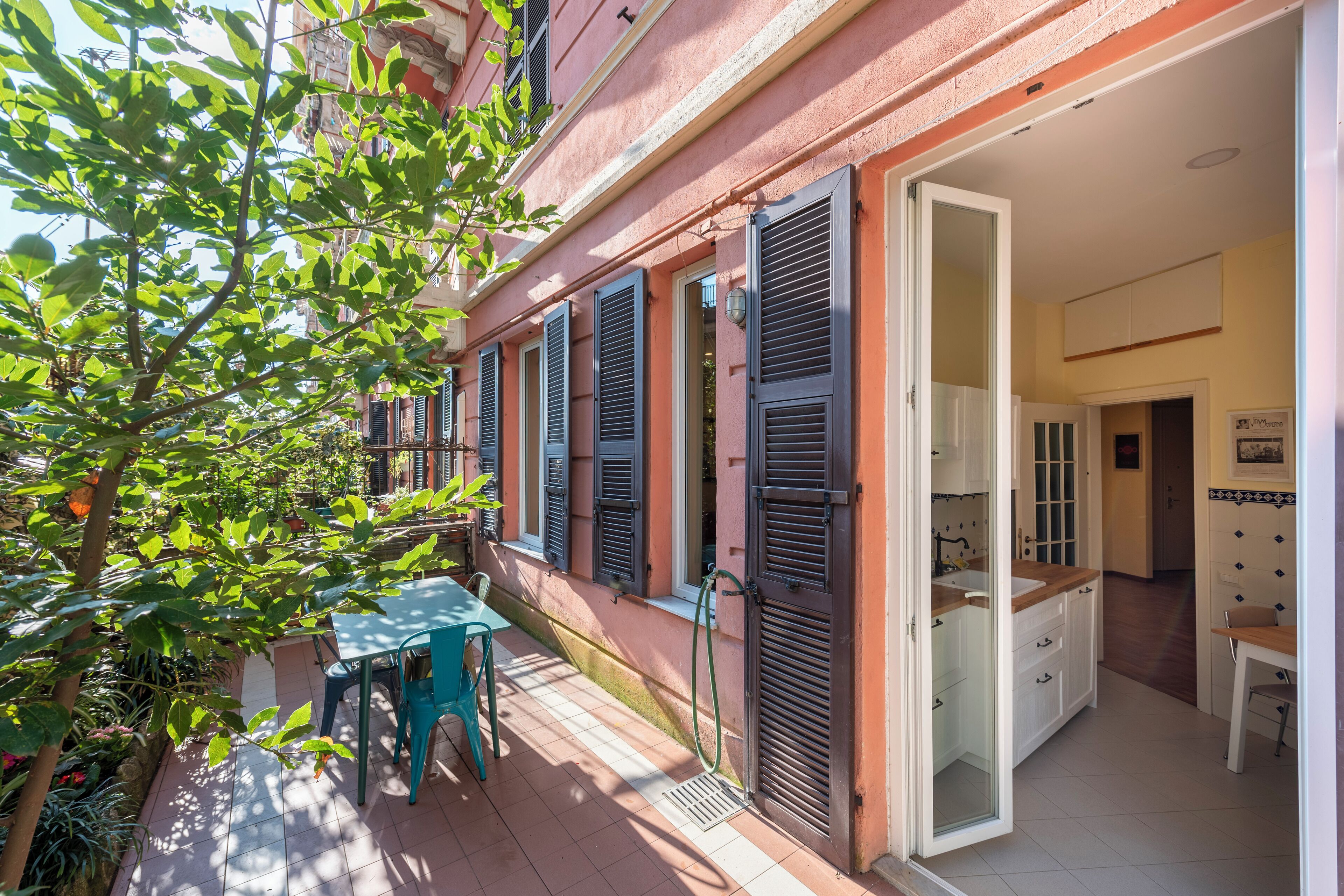 A small apartment with a balcony, a kitchen, and a dining area.