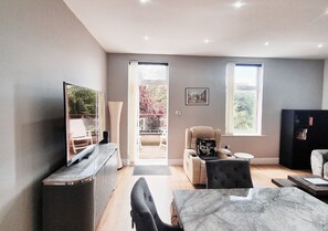 Apartment, Balcony, Garden View | Living area | 65-inch Smart TV with digital channels, Netflix, streaming services