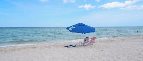 Beach nearby, white sand, beach umbrellas, beach towels