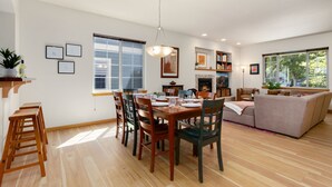 A spacious living area with a dining table set for four, a sofa, and a fireplace. - Rigden Retreat | Garage, Dog Friendly, Near Trails (Fort Collins)