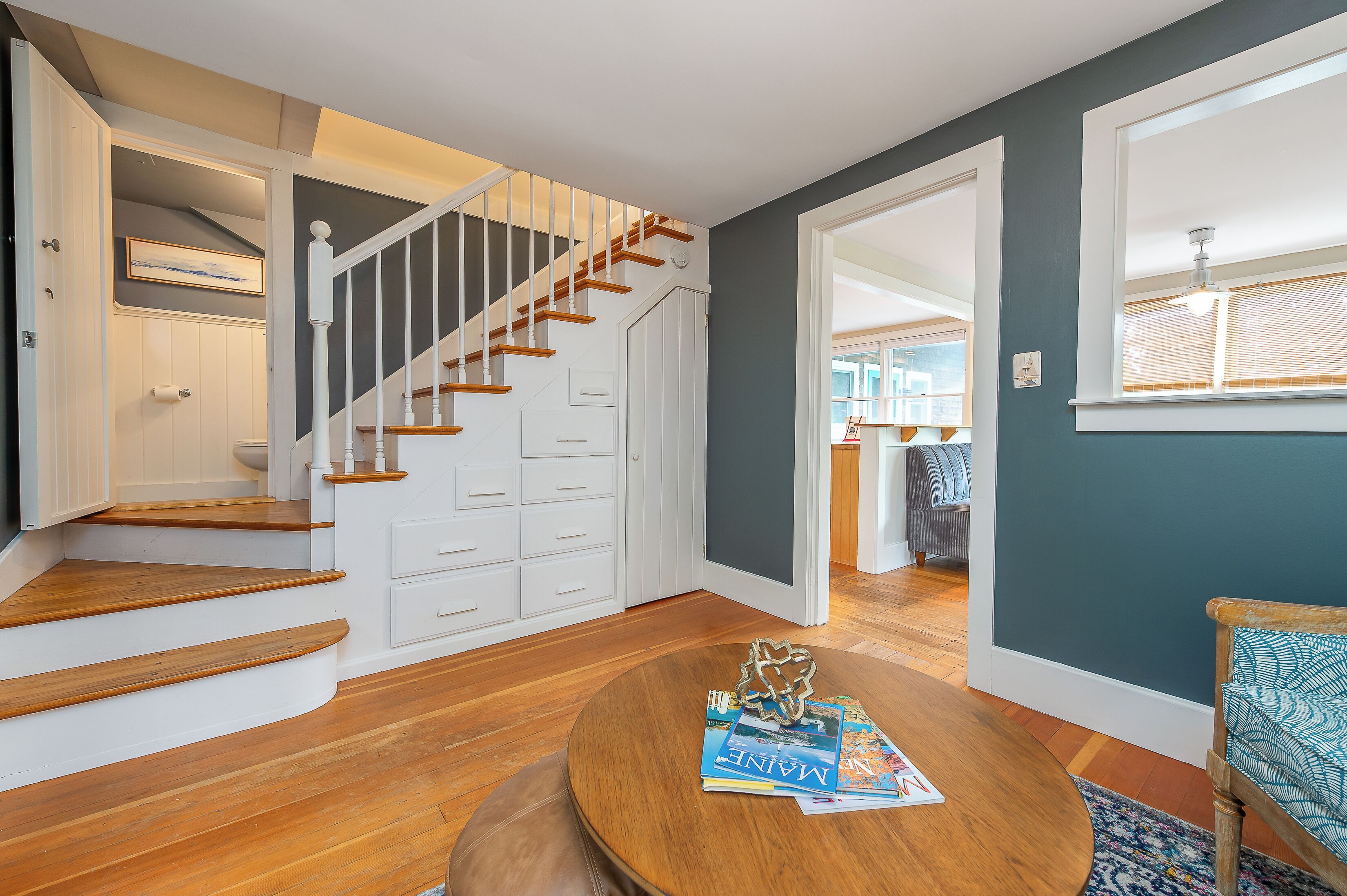 A staircase with wooden steps and white railings leading to a landing.