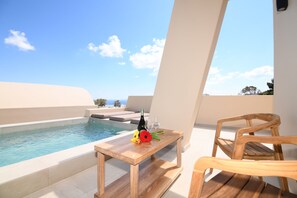 A wooden table with a bottle and glasses by a pool, with a clear view of the sky and distant trees. - Santorini - Villa - Sleeps 4 - Pool - Parking (Santorini)
