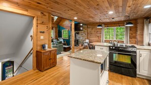 A cabin interior with a kitchen, dining area, and living room. - 15 MINUTES FROM ASHEVILLE! Secluded peacefull LOG CABIN (Leicester)