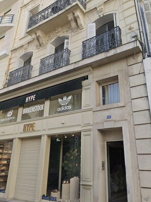 A building with multiple storefronts, including HYPE, Birkenstock, and Adidas.