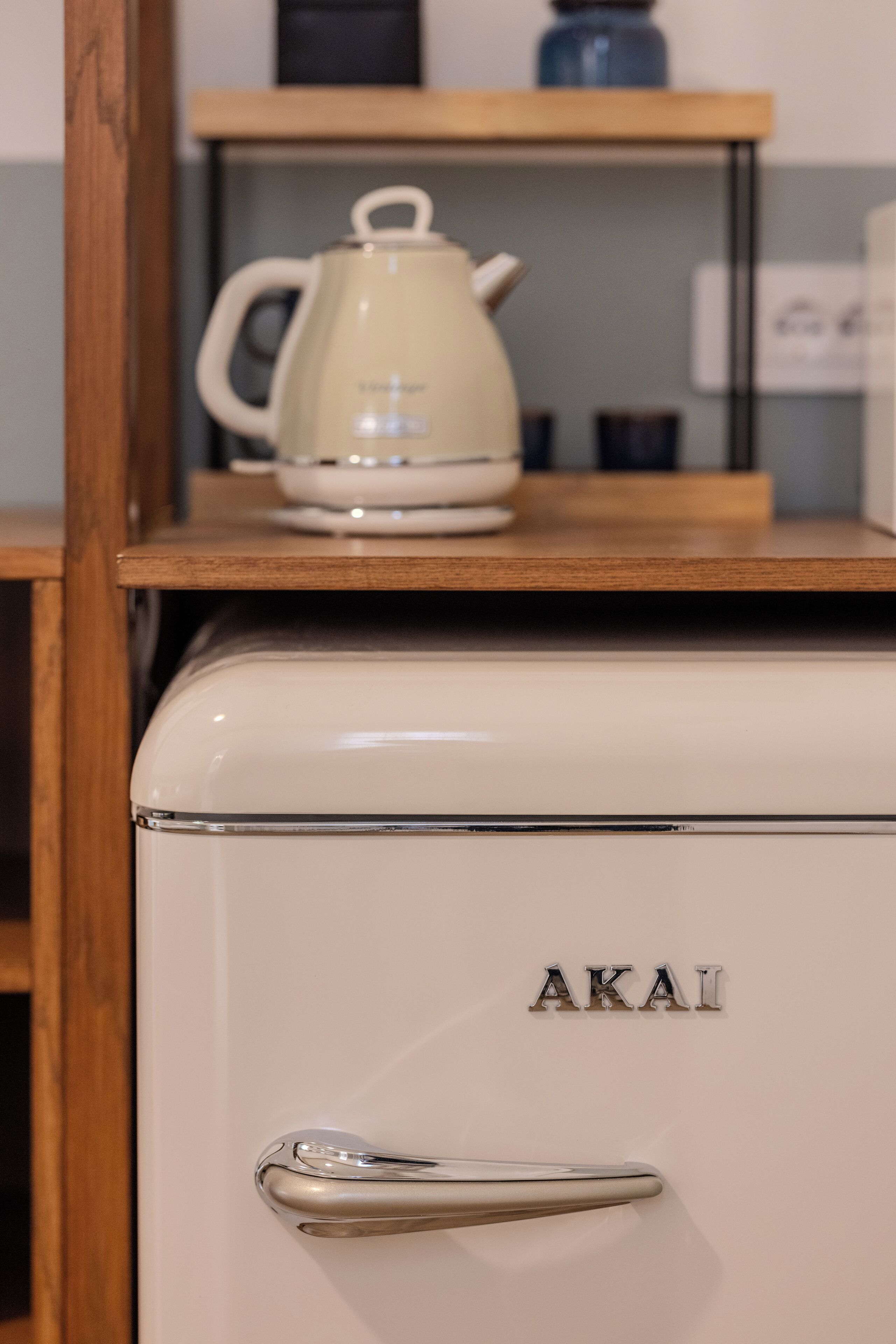 A vintage white refrigerator with the brand name "AKAI" on the door.