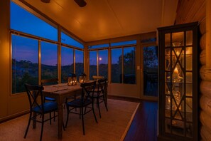 A dining area with a table and chairs, large windows, and a view of the outdoors. - Lux Getaway by Center Hill Lake - Hot Tub - 3BD/3BA + Bunk Room (Smithville)