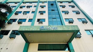 A high-rise building with a sign reading "People's Condominium San Rafael." - Award-winning Stay in Iloilo (Iloilo)