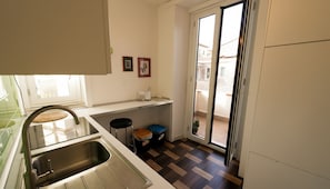 A kitchen with a sink, countertop, and a view to the outside. - Bonaventura House - House near Mount Etna (Unknown)
