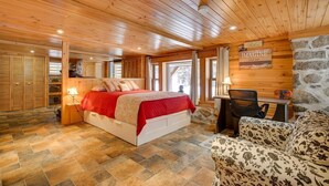 A wooden-paneled bedroom with a bed, a desk, and a chair. - DOMAINE BONHEURA; A HAVEN OF PEACE SURROUNDED BY NATURE IN ABUNDANCE! (Val-David)