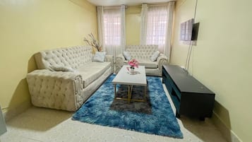 Family Apartment, City View | Living area | 24-inch Smart TV with digital channels
