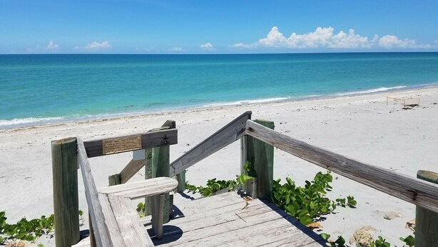 A wooden boardwalk leading to a beach with clear turquoise water and a clear sky. - Island Oasis on Manasota Key- Steps to both Gulf & Bay Access, Heated Pool (Englewood)